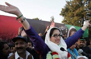 Former Pakistani Prime Minister Benazir Bhutto waves to her supporters at Liaquat Bagh in Rawalpindi, Pakistan, Dec. 27, 2007. Bhutto died Thursday as Party security adviser says she was shot in the neck and chest as she got into her vehicle, then gunman blew himself up. At least 20 others were also killed in a blast that took place as Bhutto left the rally. (Xinhua/AFP Photo)