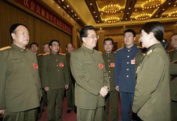 Chinese President Hu Jintao (C), who is also general secretary of the Communist Party of China (CPC) Central Committee and chairman of the Central Military Commission, talks to the deputies of the Chinese People's Liberation Army (PLA) to the First Session of the 11th National People's Congress (NPC) in Beijing, capital of China, March 10, 2008. Hu Jintao attended the plenary meeting of the PLA delegation and made a speech on Monday. (Xinhua Photo)