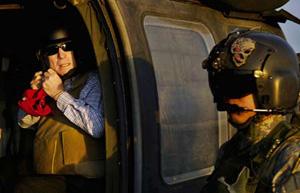 US Republican presidential candidate Senator John McCain (R-AZ) unbuckles his flight helmet as he arrives at Sather Air Base in Baghdad, March 16, 2008. Picture taken March 16, 2008. (Xinhua/Reuters Photo)