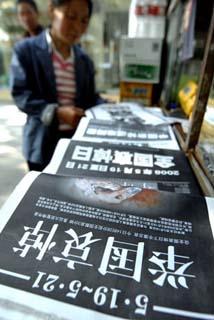A citizen looks at bold-face front pages of newspapers in Zhengzhou, capital of central China's Henan Province, May 19, 2008.  (Xinhua Photo)