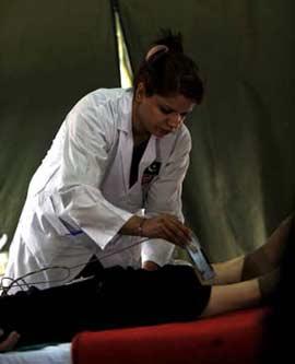 A member of the Pakistani medical team does medical checkup for a quake victim in the Wudu District of Longnan City, northwest China's Gansu Province, June 2, 2008. The 28-member Pakistani medical team has set up a tent hospital in quake-hit Longnan after it arrived in the city on May 29.(Xinhua Photo)