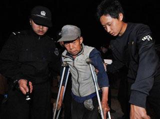 Local police help a man evacuate from quake-hit Mianzhu, southwest China's Sichuan Province, June 4, 2008. More than 14,000 people were to be evacuated by Thursday as potential landslides and mud-rock flows threatened the security of villagers in Hanwang Town in Mianzhu City, Sichuan Province, the local authorities said late Wednesday.(Xinhua Photo)