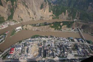 Picture taken on June 10, 2008 from a military helicopter shows flood water flowing past Beichuan County in southewest China's Sichuan Province. Drainage of the Tangjiashan quake lake through a manmade spillway speeded up to 1,760 cubic meters per second at 9:30 am on Tuesday, whereas water flow in the lower reaches of the lake, in Beichuan County, reached 2,240 cubic meters per second. (Xinhua/Li Gang)
