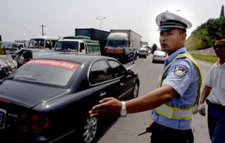 Traffic police directs the traffic along the bank of the Fujiang River in Mianyang city,southewest China's Sichuan Province, June 10,2008. (Xinhua Photo)