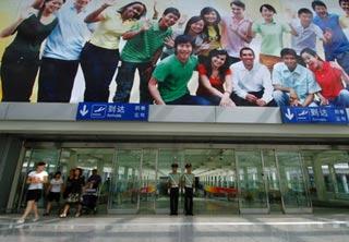 Two armed policemen guard at terminal 3 of the Beijing Capital International Airport in Beijing, China, July 20, 2008. (Xinhua Photo)