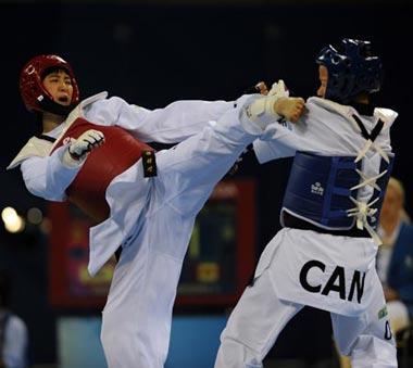 Karine&nbsp;Sergerie&nbsp;(blue)&nbsp;of&nbsp;Canada&nbsp;fights&nbsp;with&nbsp;Hwang&nbsp;Kyungseon&nbsp;of&nbsp;South&nbsp;Kroea&nbsp;during&nbsp;the&nbsp;women's&nbsp;67kg&nbsp;gold&nbsp;medal&nbsp;match&nbsp;at&nbsp;the&nbsp;Beijing&nbsp;2008&nbsp;Olympic&nbsp;Games&nbsp;taekwondo&nbsp;event&nbsp;in&nbsp;Beijing,&nbsp;China,&nbsp;Aug.&nbsp;22,&nbsp;2008.&nbsp;Hwang&nbsp;Kyungseon&nbsp;won&nbsp;the&nbsp;match&nbsp;and&nbsp;gained&nbsp;the&nbsp;gold&nbsp;medal.&nbsp;(Xinhua/Zou&nbsp;Zheng)