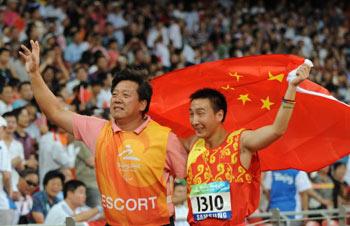 Zhu&nbsp;Pengkai&nbsp;(R)&nbsp;of&nbsp;China&nbsp;is&nbsp;escorted&nbsp;by&nbsp;his&nbsp;guide&nbsp;as&nbsp;he&nbsp;celebrates&nbsp;after&nbsp;winning&nbsp;the&nbsp;final&nbsp;of&nbsp;the&nbsp;men's&nbsp;javelin&nbsp;F11-12&nbsp;classification&nbsp;event&nbsp;at&nbsp;the&nbsp;2008&nbsp;Beijing&nbsp;Paralympic&nbsp;Games&nbsp;in&nbsp;Beijing&nbsp;on&nbsp;September&nbsp;10,&nbsp;2008.
