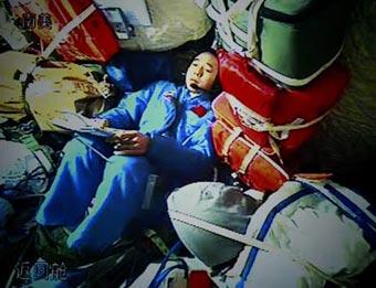 The video grab taken on Sept. 27, 2008 at the Beijing Space Command and Control Center in Beijing, China, shows Chinese taikonaut Jing Haipeng communicates with the command and control center at the re-entry module in Shenzhou-7. Chinese taikonauts began the activities of China's first spacewalk on Saturday afternoon. (Xinhua/Zha Chunming)