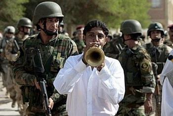 Iraqi security forces provide security as Iraqi musicians perform during a ceremony for the reopening of a part of Al-Rashid Street from Al-Bab Al-Muadham street to Al-Rasafi square in Baghdad.(AFP/Ahmad al-Rubaye)