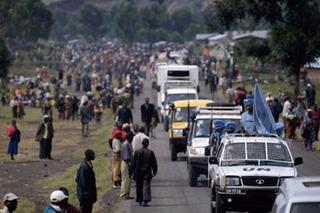 A UN convoy, seen here crossing a camp in Kibati 10km (six miles) north of Goma, has brought desperately needed humanitarian assistance to the rebel-held town of Rutshuru as aid agencies begin tracking down more than a million people trapped by fighting in eastern Democratic Republic of Congo.(AFP/Walter Astrada)