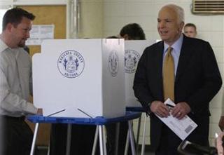 Republican presidential nominee Senator John McCain enters the polling place with his ballot in hand to casts his vote in the general election in Phoenix, November 4, 2008.(Jessica Rinaldi/Reuters)