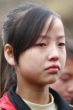 A girl who survived the May 12 earthquake grieves for her classmates and teachers who died in Wenchuan Earthquake in the Donghekou Earthquake Relics Park in Qingchuan county of southwest China's Sichuan Province, Nov. 12, 2008. Donghekou Earthquake Relics Park, the first memorial park of Wenchuan Earthquake, opend to the public on Wednesday.(Xinhua/Zhong Min)