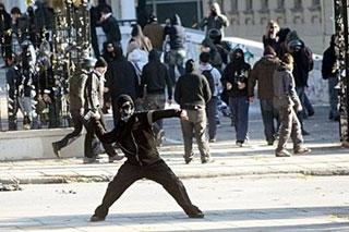 Youths clash with riot police outside the Aristotelio University in the northern Greek city of Thessaloniki.(AFP/Sakis Mitrolidis)