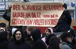 Left-wing protestors shout slogans outside the Greece consulate in Berlin, December 8, 2008, after others forcibly entered the building to demonstrate against the fatal shooting of a Greek teenager in Athens by police over the weekend. (Fabrizio Bensch/Reuters)