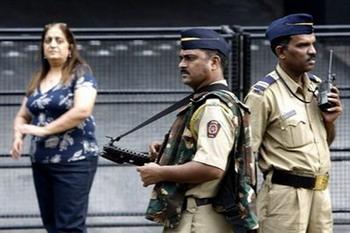Guest and security staff at the main entrance of the Trident hotel in Mumbai on December 21, 2008. Two luxury hotels that were stormed by Islamist militants re-opened in Mumbai Sunday, less than a month after devastating attacks that rocked India's financial and entertainment capital.(AFP/Sajjad Hussain)
