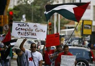 Demonstrators hold up placards in front of the Israeli embassy in Caracas, December 29, 2008, during a protest against Israel's attacks on Gaza. REUTERS/Alejandro Rustom