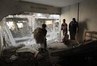 Palestinians survey their damaged house after an Israeli air strike in Gaza January 5,2009.(Mohammed Salem/Reuters)