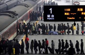 Travellers queue up to get on the train.