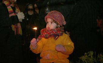 An Irani child holds a candle while praying for the children in Gaza during a rally at the Palestine Square in Tehran, capital of Iran, Jan. 7, 2009. Thousands of Irani people gathered at the square Wednesday night to support the Palestinian people.(Xinhua/Che Ling)