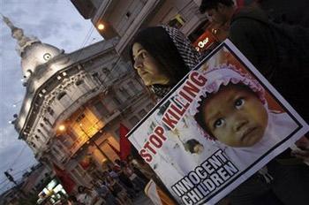 A demonstrator holds a sign during a protest against Israel's military strikes on the Gaza Strip in Asuncion, Paraguay, Friday, Jan. 9, 2009. (AP Photo/Rene Gonzalez)