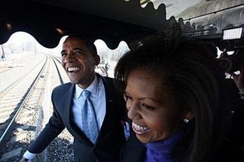 US President-Elect Barak Obama and wife Michelle Obama during the first slow roll at Myrtle and Marion Avenues, Claymont, DE, on the way to Wilmington, DE, during Whistle Stop tour. Cheered by rejoicing thousands, Barack Obama Saturday steeled Americans to conquer crises at home and abroad, launching his inaugural party with a triumphant train tour to Washington.(AFP/Pool/Chang W. Lee)