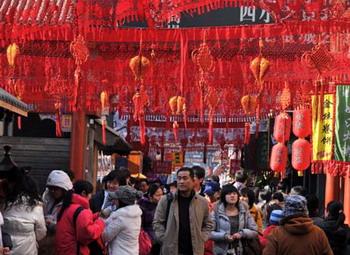 Tourists visit the bustling snack street of Wangfujing Street in Beijing, capital of China, Jan. 18, 2009, the traditional Chinese 