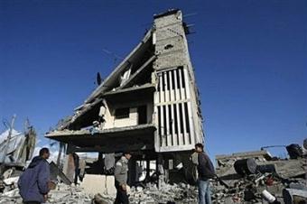 Palestinians returning to their homes stand by a destroyed building in Beit Lahia on the northern Gaza Strip. As Hamas congratulated Palestinians on their "victory" from mosque loudspeakers on Sunday, shell-shocked residents surveyed the debris of the deadliest offensive ever launched by Israel on Gaza.(AFP/Mahmud Hams)