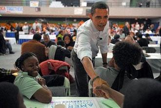 US President-elect Barack Obama greets a volunteer at a National Day of Service Project event where volunteers were writing letters for troop at Coolidge Senior High School in Washington.(AFP/Mandel Ngan)