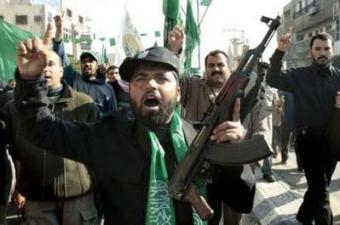 A Hamas police officer raises his right finger while chanting in Arabic "there is only one god and that is Allah" during a pro-Hamas demonstration in Gaza City January 20, 2009.REUTERS/Mohammed Salem