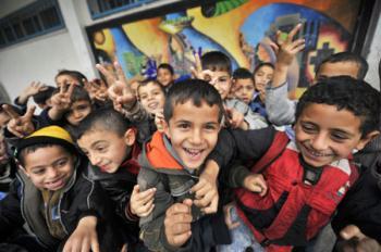 Gaza children pose for photos during their break in the Beit Loliya Boys Elementary School in Gaza city Jan. 24, 2009. Some 200,000 Gaza children returned to school for the first time since Israel‘s offensive. (Xinhua/Zhang Ning)