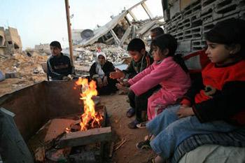 Palestinians&nbsp;get&nbsp;warm&nbsp;by&nbsp;a&nbsp;fire&nbsp;in&nbsp;the&nbsp;rubbles&nbsp;in&nbsp;al&nbsp;Moghraqa&nbsp;area&nbsp;in&nbsp;the&nbsp;central&nbsp;Gaza&nbsp;Strip,&nbsp;Jan.&nbsp;29,&nbsp;2009.&nbsp;The&nbsp;reconstruction&nbsp;of&nbsp;Gaza&nbsp;Strip&nbsp;after&nbsp;a&nbsp;ceasefire&nbsp;is&nbsp;almost&nbsp;at&nbsp;a&nbsp;standstill&nbsp;due&nbsp;to&nbsp;the&nbsp;continuous&nbsp;blockage&nbsp;of&nbsp;Gaza&nbsp;by&nbsp;Israel&nbsp;and&nbsp;different&nbsp;opinions&nbsp;on&nbsp;receiving&nbsp;international&nbsp;aid&nbsp;in&nbsp;the&nbsp;Palestinian&nbsp;side.&nbsp;(Xinhua/Wissam&nbsp;Nassar)&nbsp;