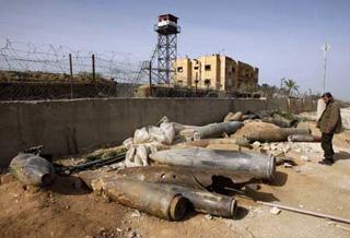 A member of Hamas security forces looks at the remains of spent ammunition and unexploded bombs, fired by Israeli warplanes during Israel's 22-day offensive, in Rafah in the southern Gaza Strip January 26, 2009.(Xinhua/Reuters Photo)