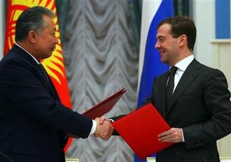 Russian President Dmitry Medvedev, right, and Kyrgyz President Kurmanbek Bakiyev exchange documents during a signing ceremony at the Kremlin in Moscow, Tuesday, Feb. 3, 2009.(AP Photo/Alexander Nemenov, Pool)