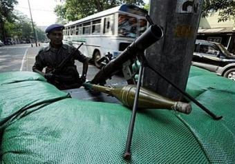 A Sri Lankan soldier stands guard at a security check point in Colombo. Sri Lanka's president predicted Wednesday the total defeat of Tamil Tigers rebels within 