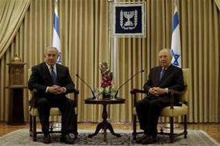 Israel's President Shimon Peres, right, sits with Likud Party leader Benjamin Netanyahu during their meeting at the President's residence in Jerusalem Friday, Feb.20, 2009. Netanyahu of the hawkish Likud Party has received formal permission from Israel's ceremonial president to put together the country's next government. At a ceremony at President Shimon Peres' residence, Netanyahu urged Foreign Minister Tzipi Livni of the governing Kadima Party and Defense Minister Ehud Barak of the Labor Party to join his government.(AP Photo/Dan Balilty)