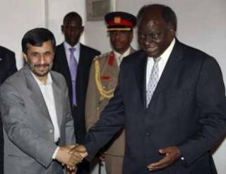 Iran's President Mahmoud Ahmadinejad (L) is welcomed by Kenya's President Mwai Kibaki at State House in Nairobi, February 24, 2009.REUTERS/Presidential Press Service/Handout