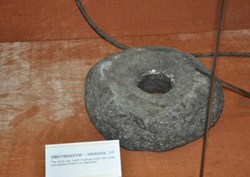 A stone cap that was used to gouge eyes of serfs in a Lhasa prison in old Tibet is on display at an exhibition marking the 50th anniversary of the Democratic Reform in Tibet Autonomous Region in Beijing, Feb. 25, 2009. (Xinhuanet Photo)