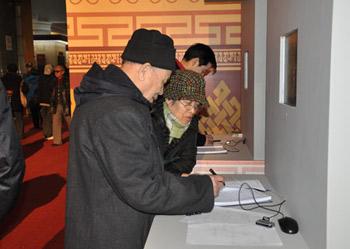 Visitors leave messages after watching the exhibition marking the 50th anniversary of the Democratic Reform in Tibet Autonomous Region in Beijing, Feb. 25, 2009.(Xinhuanet Photo)
