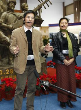 Zhang Yun (L) and Degyi Zhoema, researchers of the Tibetology Research Center of China, answer questions from foreign correspondents at the "50th Anniversary of Democratic Reforms in Tibet" Exhibition in Beijing, capital of China, March 18, 2009. A number of foreign journalists, organized by the Information Department of China's Foreign Ministry, visited the exhibition on Wednesday. (Xinhua/Li Mingfang)