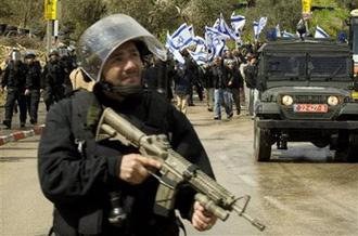 Israeli police escort right-wing extremists as they march in the northern Israeli Arab village of Umm El-Fahm Tuesday, March 24, 2009.(AP Photo/Sebastian Scheiner)
