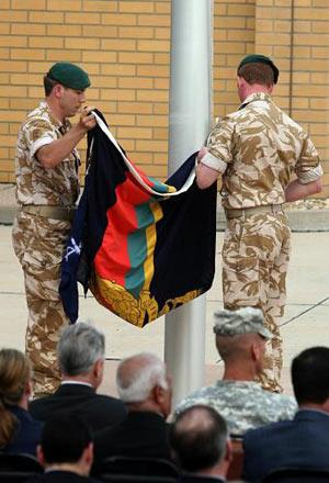 British Royal Marines lower their unit's flag in Basra as they launched their pullout from Iraq March 31, 2009. (Xinhua/AFP Photo)