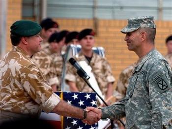 In this image made available by the Ministry of Defence in London, Tuesday March 31, 2009, Britain's Major General Andy Salmon, left, former head of coalition operations in South East Iraq, shakes hands with US General Michael Oates to hand over military command of coalition forces in Basra, at a ceremony at Basra International Airport, Iraq, Tuesday March 31, 2009. The ceremony is seen as the start of the final withdrawl of British troops from Iraq.(AP Photo/Adrian Harlen, MOD, ho)