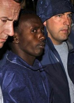 FBI agents escort the Somali pirate U.S. officials identified as Abduhl Wali-i-Musi into FBI headquarters in New York on Monday, April 20, 2009. Abduhl Wal-i-Musi is the sole surviving Somali pirate from the hostage-taking of commercial ship captain Richard Phillips.(AP Photo/Louis Lanzano)
