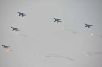 Military aircrafts are seen during a naval parade of the Chinese People's Liberation Army (PLA) Navy warships and aircraft in waters off China's port city of Qingdao, east China's Shandong Province, on April 23, 2009. (Xinhua/Li Gang)