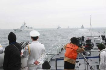 A naval parade of the Chinese People's Liberation Army (PLA) Navy warships and aircraft is held in waters off China's port city of Qingdao, east China's Shandong Province, on April 23, 2009. (Xinhua/Li Gang)