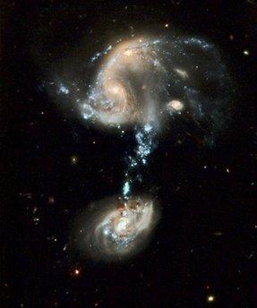 with a 'cosmic fountain' of stars, gas, and dust that stretches over 100,000 light-years. The most striking feature of this galaxy troupe is the impressive blue stream of material extending from the northern component. This 'fountain' contains complexes of super star clusters, each one of which may contain dozens of individual young star clusters. The blue color is produced by the hot, massive stars which dominate the light in each cluster. Overall, the 'fountain' contains many millions of stars. This picture was issued to celebrate the 19th anniversary of the launch of the Hubble Space Telescope aboard the space shuttle Discovery in 1990. During the past 19 years Hubble has made more than 880,000 observations and snapped over 570,000 images of 29,000 celestial objects. The Space Shuttle Discovery placed the Hubble Space Telescope into Earth orbit on April 25, 1990.(AP Photo/NASA) 