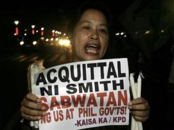 Smith, sentenced to life imprisonment three years ago by a lower court on charges of raping a Filipina, was ordered to be set free, the 71-page ruling said. The placard read 'Acquittal of Smith, conspiracy between U.S. and Philippine governments'.REUTERS/Romeo Ranoco