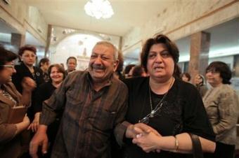 People grieve at a gathering inside a Chaldean Christian church in Kirkuk, 290 kilometers (180 miles) north of Baghdad, Iraq, Monday, April 27, 2009, after unknown attackers killed three Christians a day earlier.(AP Photo/Yahya Ahmed)