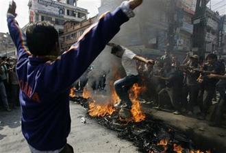 Supporters of Nepal's opposition political parties, who are against Prime Minister Pushpa Kamal Dahal's decision to fire army chief Rookmangud Katawal, set fire on old tires and block roads during a protest in Katmandu, Nepal, Sunday, May 3, 2009.(AP Photo/Gemunu Amarasinghe)
