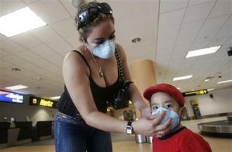 A&nbsp;woman&nbsp;adjusts&nbsp;a&nbsp;face&nbsp;mask&nbsp;on&nbsp;a&nbsp;child&nbsp;as&nbsp;a&nbsp;precaution&nbsp;against&nbsp;swine&nbsp;flu&nbsp;as&nbsp;they&nbsp;wait&nbsp;for&nbsp;their&nbsp;baggage&nbsp;at&nbsp;the&nbsp;Jorge&nbsp;Chavez&nbsp;airport&nbsp;in&nbsp;Callao,&nbsp;Peru&nbsp;Thursday,&nbsp;April&nbsp;30,&nbsp;2009.(AP&nbsp;Photo/Karel&nbsp;Navarro)